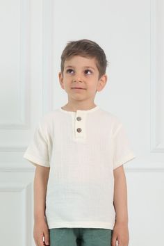 Introducing our trendy and eco-friendly Organic Cotton Muslin T-Shirt for Kids, made from double gauze organic 100% cotton fabric. Muslin is a breathable, pliable, and gentle material, ideal for the delicate skin type of kids. Due to its fabric structure, muslin is particularly fluid, soft, fluffy, and therefore comfortable to wear, making it perfect for all seasons. This short-sleeved shirt features two buttons on the front and is available in 3T-4T-5T-6T-7T US Kids sizes. You can wash and spin Basic Short Sleeve Cotton Top, White Organic Cotton Tops For Summer, White Organic Cotton Summer Tops, Basic Organic Cotton Short Sleeve Tops, Casual Organic Cotton Short Sleeve Top, Casual Cotton Crew Neck Short Sleeve Shirt, Basic Long Sleeve Shirt For Summer, Organic Cotton Short Sleeve Tops For Summer, Summer Organic Cotton Short Sleeve Tops