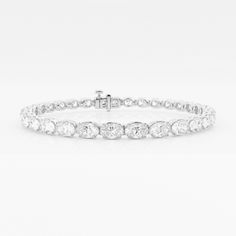 Elegant and yet unique, oval shaped diamonds are stylishly set in an east-west pattern in this beautiful tennis bracelet. Lab grown diamonds, as unique as you, glisten through this gorgeous setting, making the light dance to your tunes. Fine Jewelry Oval Diamond Bracelet With Accents, Oval Diamond Bracelet With Diamond Accents, Oval Diamond Bracelet With Accents, Oval Tennis Bracelet With Diamond Accents For Anniversary, Oval Brilliant Cut Fine Jewelry Bracelets, Oval Tennis Bracelet With Diamond Accents For Formal Events, Oval Tennis Bracelet With Diamond Accents For Formal Occasions, Classic Oval Diamond Bracelet For Anniversary, Luxury Oval Tennis Bracelet With Diamond Accents