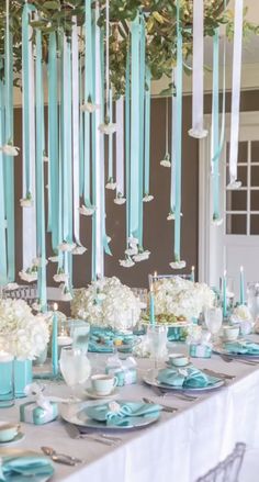 the table is set with blue and white decorations