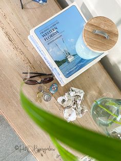 a wooden table topped with sunglasses and other items