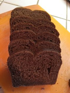 a loaf of chocolate cake sitting on top of a cutting board