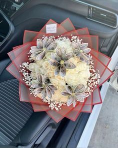 a bouquet of flowers sitting on the dashboard of a car