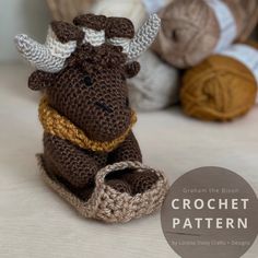 a crocheted moose sitting on top of a basket