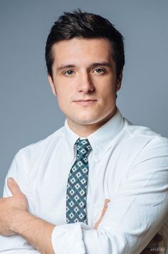 a man wearing a white shirt and blue tie