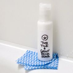 a white bottle sitting on top of a counter next to a blue and white towel