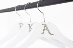 two white hangers with the letters k and a on them