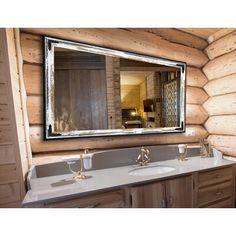 there is a bathroom with two sinks and a large mirror on the wall above it