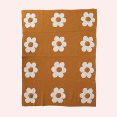 a brown blanket with white flowers on it