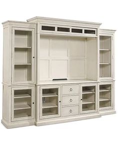 a white entertainment center with open shelves and drawers on each side, in front of a white background