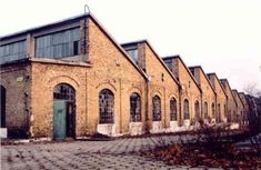 an old brick building with many windows and doors