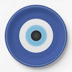 a blue plate with an eyeball design on the front and center, set against a white background