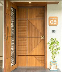 a wooden door with a plant next to it in front of a sign that says capital 50