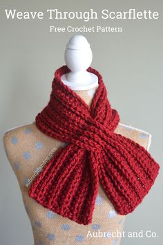 a red knitted scarf on top of a mannequin