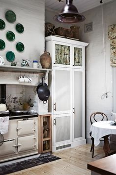 the kitchen is clean and ready to be used for cooking or baking, with dishes hanging on the wall