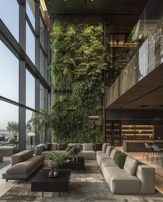 a living room filled with lots of furniture and plants on the wall above it's windows