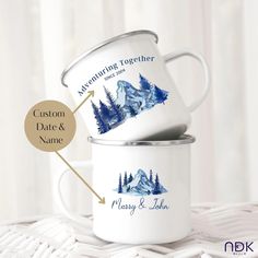 two white coffee mugs with mountains and trees on them, labeled custom date and name