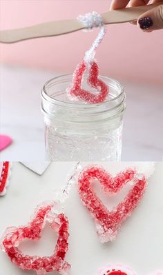 a jar filled with red and white lollipop hearts