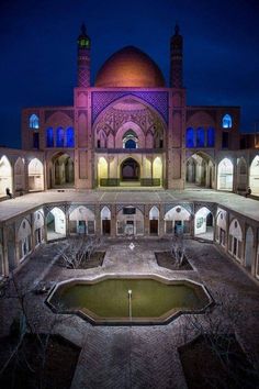 an old building with a pool in the middle