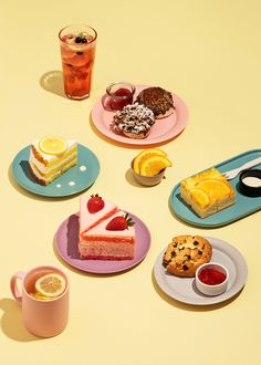 there are many different desserts on the plates next to eachother with drinks