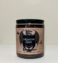 a jar of dragon river candle sitting on a table