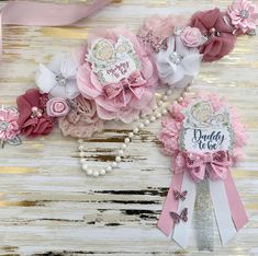 three pink and white hair clips on top of each other next to a ribbon with the word daddy in it