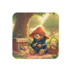 a painting of a teddy bear sitting on a picnic blanket next to a basket with apples