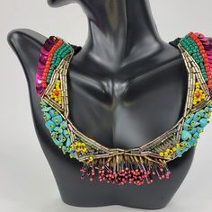 Branded by Seyyah, this colorful "social necklace" is a perfect staple pieces to elevate your everyday look. Crochet based embroidery statement necklace Adorned with seed and bugle beads, sequins, and semiprecious gemstones Two snaps to adjust the length Black crochet base length: 19-21", weight 1.6 oz About the brand: Seyyah is a brand that offers bold, unique, and colorful accessories inspired by travels around the world... and most importantly help to empower women. The brand "provides fair w Artisan Multicolor Beaded Necklaces With Fringe, Artisan Multicolor Beaded Necklace With Fringe, Embellished Multicolor Necklace For Party, Embellished Multicolor Party Necklaces, Multicolor Embellished Party Necklaces, Multicolor Embellished Party Necklace, Bohemian Embellished Necklaces For Party, Party Embellished Beaded Necklaces With Round Beads, Bohemian Embellished Necklace For Party