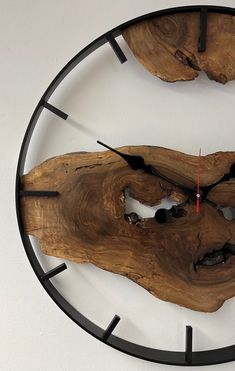 a clock made out of wood and metal with the face of a fish on it