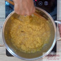 a person stirring food in a pan on top of a stove