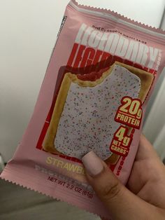 a person holding up a bag of ice cream with sprinkles on it