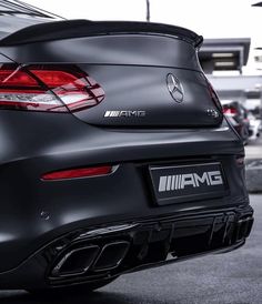 the rear end of a black mercedes car