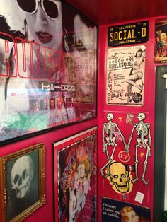 there are many pictures on the wall in this room, including posters and skeleton heads