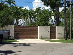 a car parked in front of a gated driveway