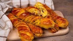 several croissants on a wooden cutting board