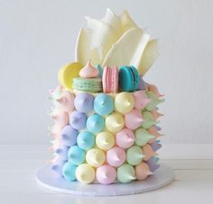 there is a colorful cake decorated with macaroons