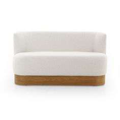 a white couch sitting on top of a wooden frame