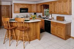 a kitchen with wooden cabinets and white tile flooring