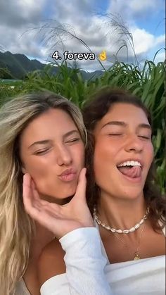 two beautiful young women standing next to each other with their mouths open and smiling at the camera