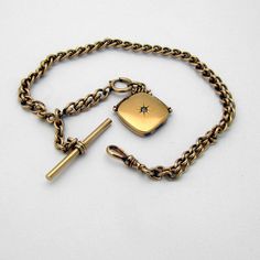 "Antique 14 K (.585) yellow gold pocket watch with an attached locket fob, accented with Diamond. This stately chain is 12 1/2\" long and 6.8 mm wide, the locket is 15/16\" square, total weight is 53.2 grams. EA2225" Gold Oval Link Locket Necklace For Formal Occasions, Formal 14k Gold Locket Necklace, Classic 14k Gold Locket Necklace For Formal Occasions, Formal Oval Link Locket Necklace With Polished Finish, Formal Polished Finish Locket Necklace With Oval Link, Classic Polished Locket Necklace For Formal Occasions, Classic Engraved Locket Necklace For Formal Occasions, Classic Locket Necklace With Polished Finish For Formal Occasions, Formal Gold Locket Necklace With Polished Finish