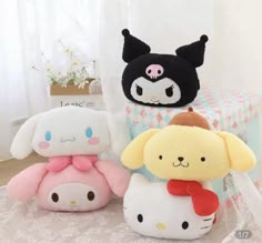 three stuffed animals sitting on top of a table