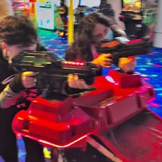 two children are playing with toys at the mall