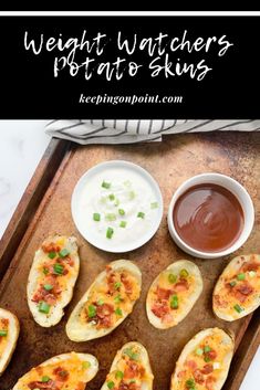 baked potato skins on a baking sheet with dipping sauce