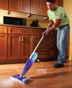 a man is cleaning the floor with a mop