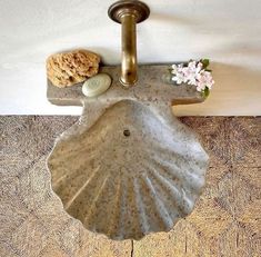 a bathroom sink sitting on top of a wooden floor next to a wall mounted faucet