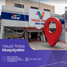 a large red marker is in front of a building with a sign that says visual tintass mujucaba