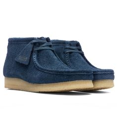 The Clarks Wallabee Boot silhouette is a signature style in the brand's repertoire. Taking on a premium suede upper, the silhouette takes on a breathable leather lining as well. The part-recycled natural rubber pebble crepe sole adds a durable touch. The two Clarks Originals fobs make an impression, while the additional laces wrap up the rest of the design. Suede upper Lace-up front Leather lining Rubber pebble crepe outsole Additional laces Two fobs All sizes are listed in U.S. Men’s sizing unl Clarks Wallabee, Boot Silhouette, Clarks Wallabees, Lace Wrap, Clarks Originals, Natural Rubber, Signature Style, Deep Blue, Two By Two