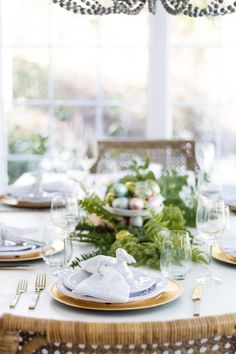 the table is set with white flowers and gold candlesticks for an elegant touch