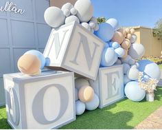 balloons and letters are on display in front of a building