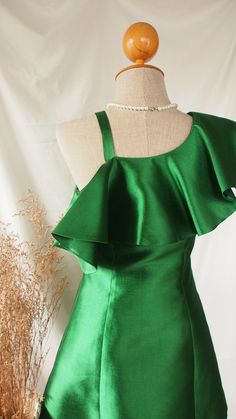 a mannequin with a green dress on it