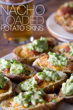 baked potato cups with guacamole and cheese on top, ready to be eaten